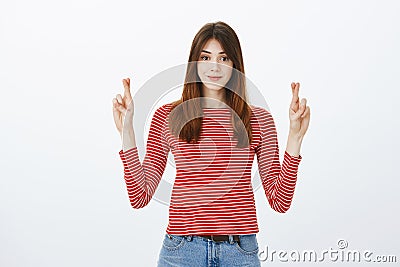 She believes in success, luck on girls side. Studio shot of confident attractive caucasian woman, holding hands up with Stock Photo