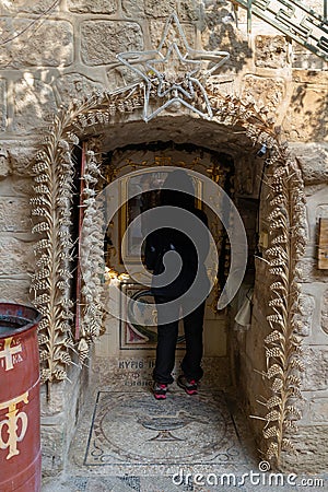 Believing woman stands and prays in front of the altar in the courtyard of the Monastery Deir Hijleh - Monastery of Gerasim of Editorial Stock Photo