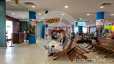 Passengers waiting for their flights inside Philip S W Goldson Airport. Editorial Stock Photo