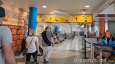 Passengers waiting for their flights inside Philip S W Goldson Airport. Editorial Stock Photo