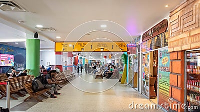 Passengers waiting for their flights inside Philip S W Goldson Airport. Editorial Stock Photo