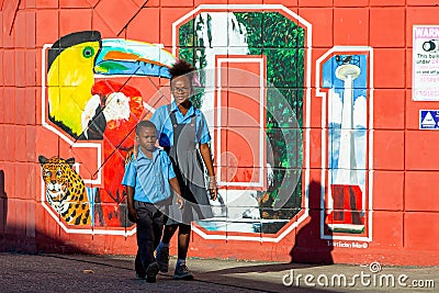 Two kids walking on the street of Belize city Editorial Stock Photo