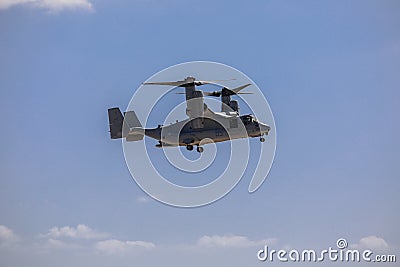 Bell Boeing V-22 Osprey Army helicopter hovering on a blue sky background. Editorial Stock Photo