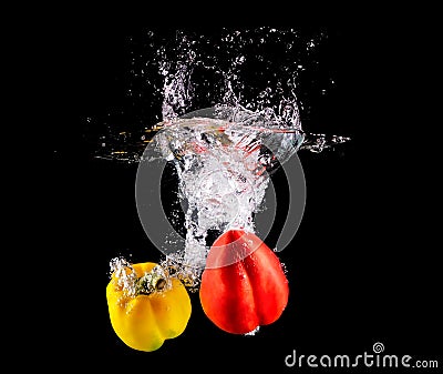 Bell pepper making splash in water. Stock Photo