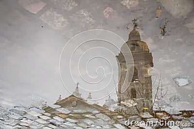 Bell tower of the Basilica of Our Lady of Pillar reflected in a puddle of water Stock Photo
