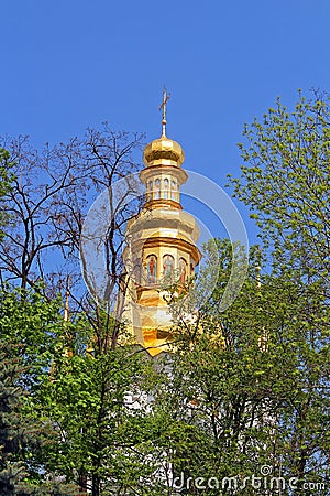 Bell tower of distant caves hidden in the spring foliage, Kyiv Stock Photo