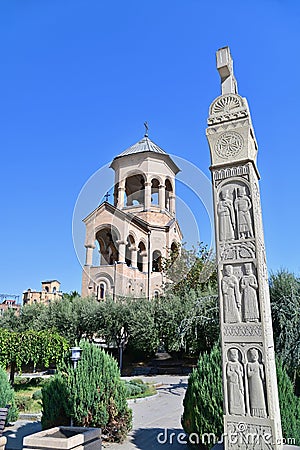 Bell Tower and Georgian Carved Pillar at Holy Trinity Cathedral of Tbilisi Stock Photo