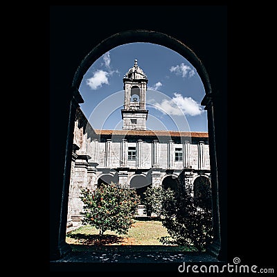 Bell tower of the Monastery of Armenteira seen through an arch. Spain. Stock Photo