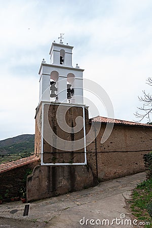 Bell tower painted white with three ancient bronze bells of two different sizes Editorial Stock Photo