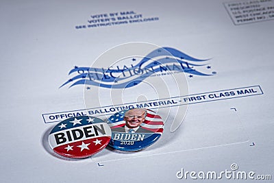 Belleville, ILâ€”Sept 30, 2020; Campaign buttons for democrat party candidate Joe Biden sit on a white and blue envelope marked as Editorial Stock Photo