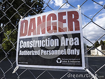 Bellevue, WA USA - circa June 2020: View of a `Danger: Construction Area` sign on a chainlink fence Editorial Stock Photo