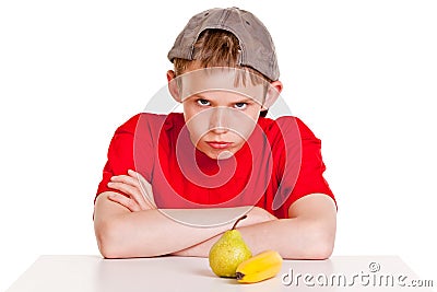 Belligerent young boy with fruit Stock Photo