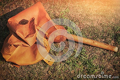 Bellows from leather to inflate the fire. Retro forge bellows on grass background Stock Photo