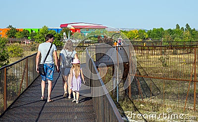 Visitors walk along the footpaths above the predator enclosures. Park `Taigan`, Crimea Editorial Stock Photo