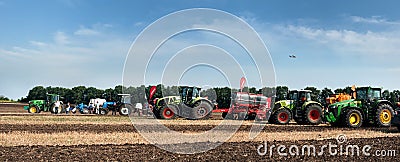 Belogorye, Khmelnytsky region, UKRAINE - August 19, 2021: tractors with seeders, plow, harrows at the demonstration of Editorial Stock Photo