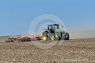 John Deere 8400R tractor pulling a Kuhn Excelerator 8000 tiller Editorial Stock Photo