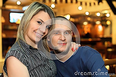 Beloved couple sits on bench Stock Photo