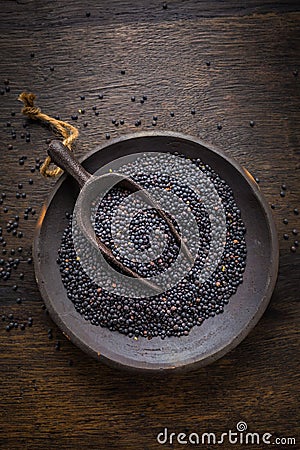 Beluga lentils on wooden background. Black lentils in bowl Stock Photo