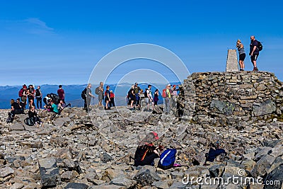 BEN NEVIS, SCOTLAND - SEPTEMBER 01 2021: Hikers on the summer of Ben Nevis on a hot, clear day. Ben Nevis is the tallest peak in Editorial Stock Photo