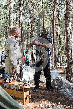 A visitor of the reconstruction `Viking Village` posing in a viking armor in the forest near Ben Shemen in Israel Editorial Stock Photo