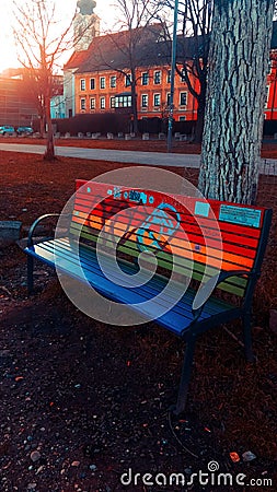 Bench with a beautiful rainbow paint Editorial Stock Photo