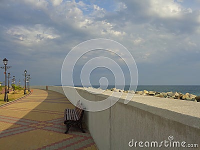 Bench on empty seaside promenade Stock Photo