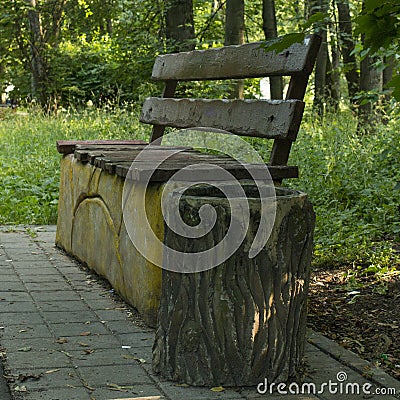 Bench, garbage container, asphalt path in the park Stock Photo