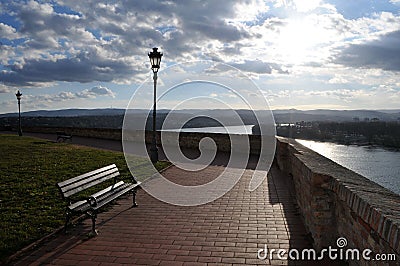 The bench next to the wall with unreachable views of the Danube and Novi Sad from the Petrovaradin Fortress Stock Photo