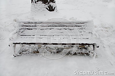 The bench in the park is covered with snow Stock Photo