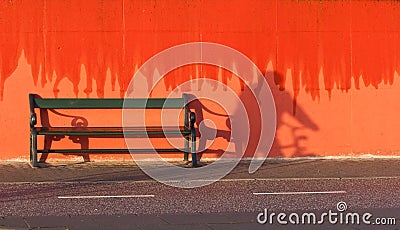 Bench and red wall. Island of Fanoe in Denmark Stock Photo