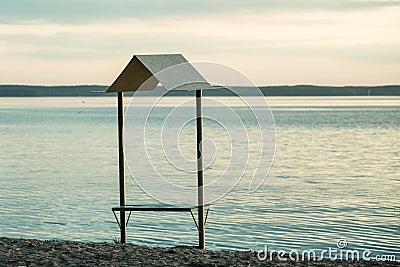 Bench on a river side facing the horizon Stock Photo