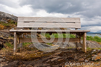 Bench by the sea bay in the fjord Stock Photo