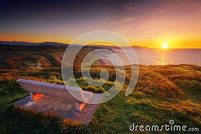 Bench at sunset with view of Azkorri beach in Getxo Stock Photo