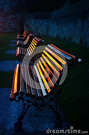Benches at sunset reflecting sunlight Stock Photo