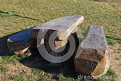 Benches and table made from a single wooden trunk in a cottage Stock Photo