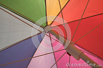 Beneath a brightly colored umbrella Stock Photo