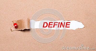 Beneath the torn strip of kraft paper attached with a red button is a white paper DEFINE Stock Photo
