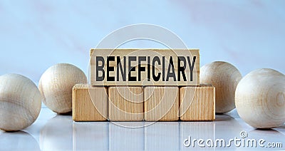 BENEFICIARY - word on wooden cubes on a light background with balls Stock Photo