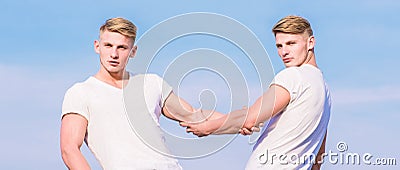Benefits of having twin brother. Friendship and support. Men muscular twins brothers in white shirts sky background Stock Photo