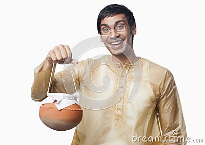 Bengali man carrying a pot of rasgulla Stock Photo