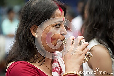 Bengali woman playing shankh Editorial Stock Photo