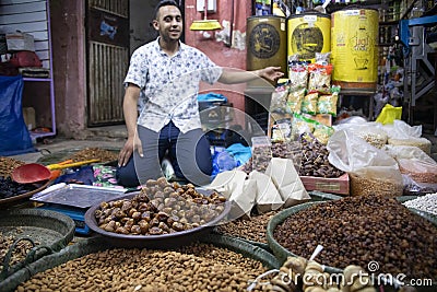 Beni Mellal, Morocco - October 10, 2022: Moroccan seller in Beni Mellal offering his Arab products. Editorial Stock Photo