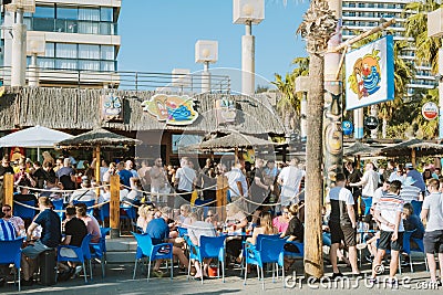 Benidorm, Spain - April 01, 2023: People enjoy vacation in popular Tiki beach bar. Benidorm - popular Spanish resort Editorial Stock Photo