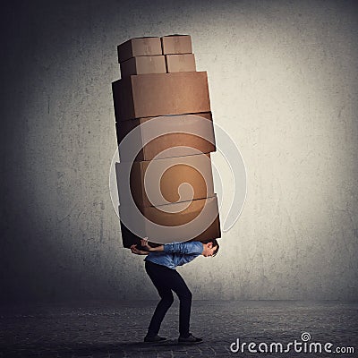 Bent down guy carrying a lot of big heavy boxes on his back. Overloaded of daily tasks, and difficult burden. Packing stuff and Stock Photo