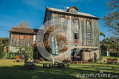 Old rural house made of wood and stone with people Editorial Stock Photo