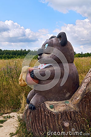 Berendeyevo, Russia, Moscow region, July 26, 2014, summer landscape with fabulous sculptures. Bear with a honey pot. Editorial Stock Photo