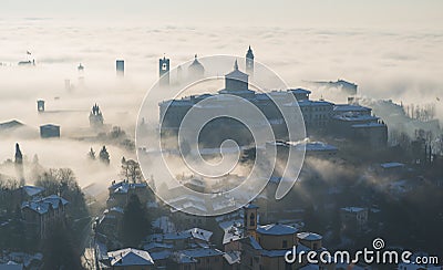 Bergamo, Italy. Lombardy. Amazing landscape of the fog rises from the plains and covers the old town Stock Photo