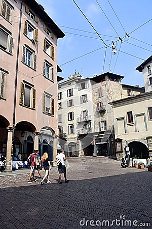 Bergamo / Italy / September 7 2018 : The lower town of Bergamo. In shaded arcades people go shopping, eating. Cobbled streets Editorial Stock Photo
