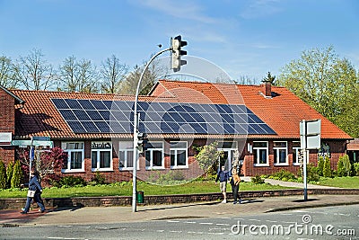 Bergen, Germany - April 30, 2017: Solar energy panel on a house roof on the blue sky background. Editorial Stock Photo