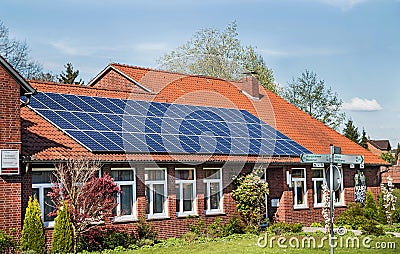 Bergen, Germany - April 30, 2017: Solar energy panel on a house roof on the blue sky background. Editorial Stock Photo